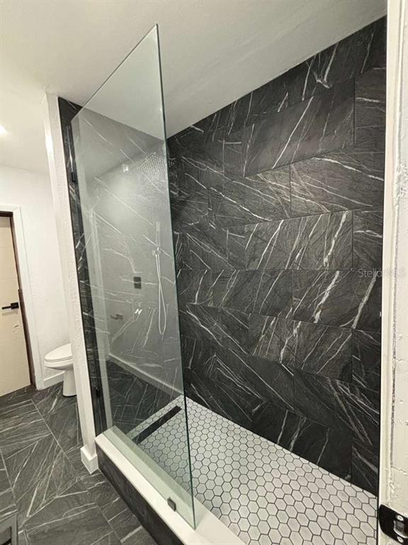 101 West Celeste Street Apopka, FL 32703 - Photo 25 of 47 a bathroom with a glass shower door