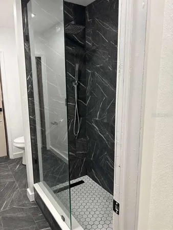 a bathroom with a glass shower door