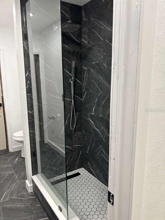 101 West Celeste Street Apopka, FL 32703 - Photo 28 of 47 a bathroom with a glass shower door