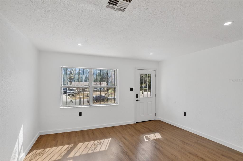 101 West Celeste Street Apopka, FL 32703 - Photo 5 of 47 wooden floor in an empty room with a window