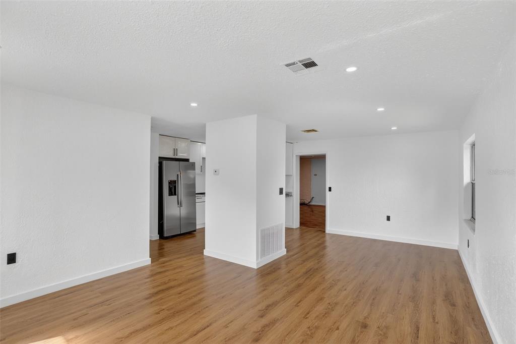 101 West Celeste Street Apopka, FL 32703 - Photo 6 of 47 a view of an empty room with wooden floor and a window