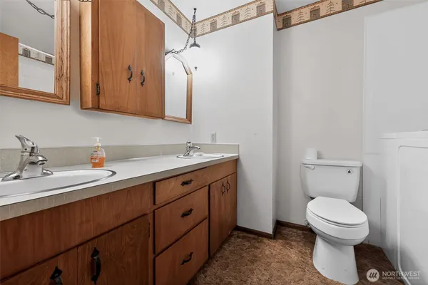 a bathroom with a toilet sink and mirror