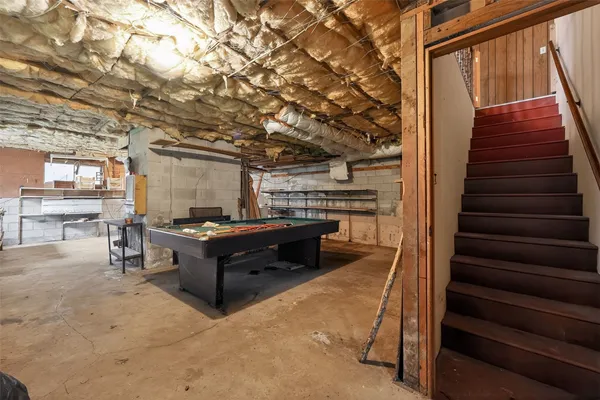 a room with stairs and a wooden floor