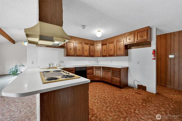 a kitchen with stainless steel appliances granite countertop a sink refrigerator and cabinets