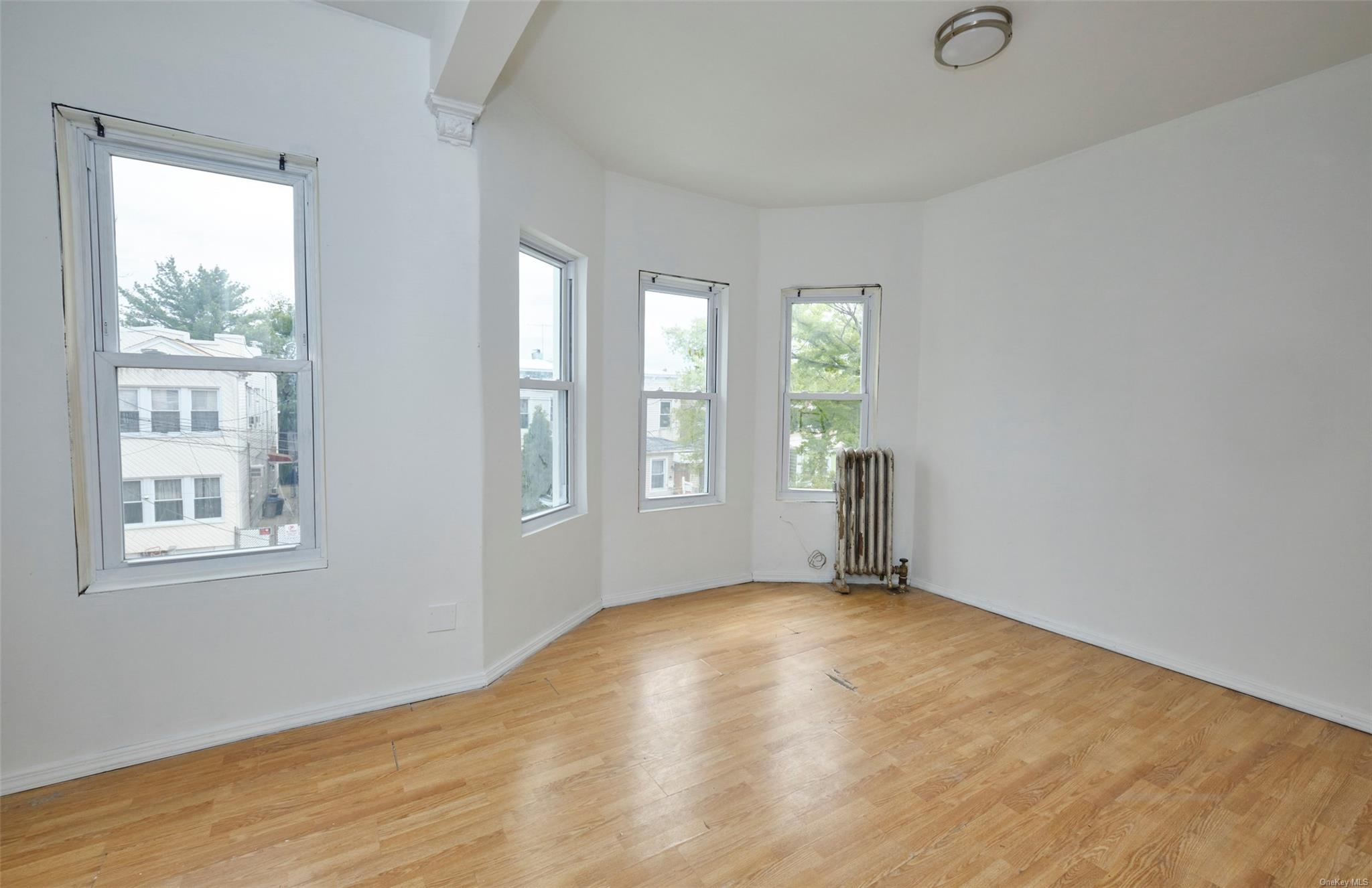 80-19 86th Road Queens, NY 11421 - Photo 11 of 26 an empty room with windows
