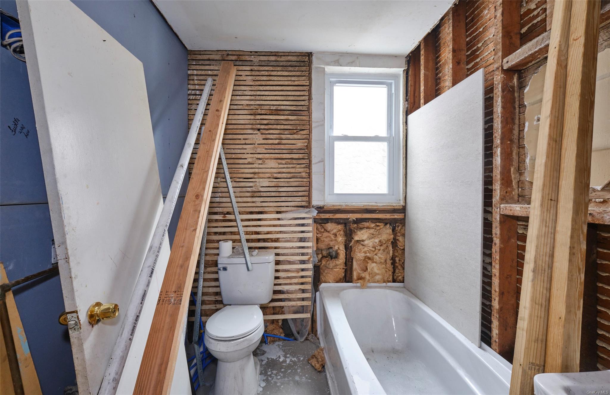 80-19 86th Road Queens, NY 11421 - Photo 14 of 26 a bathroom with a sink and toilet