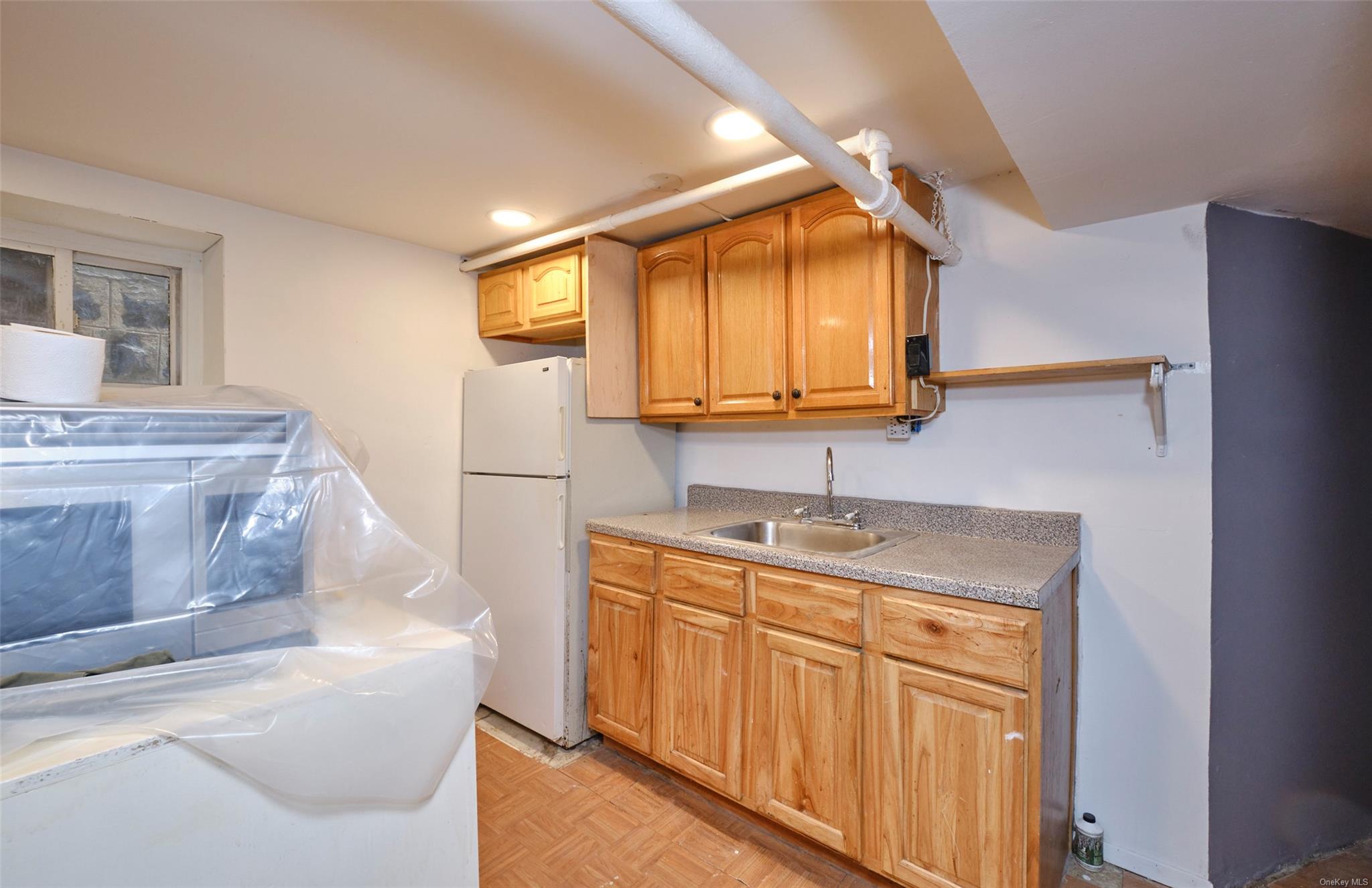 80-19 86th Road Queens, NY 11421 - Photo 16 of 26 a kitchen with stainless steel appliances granite countertop a sink stove and refrigerator