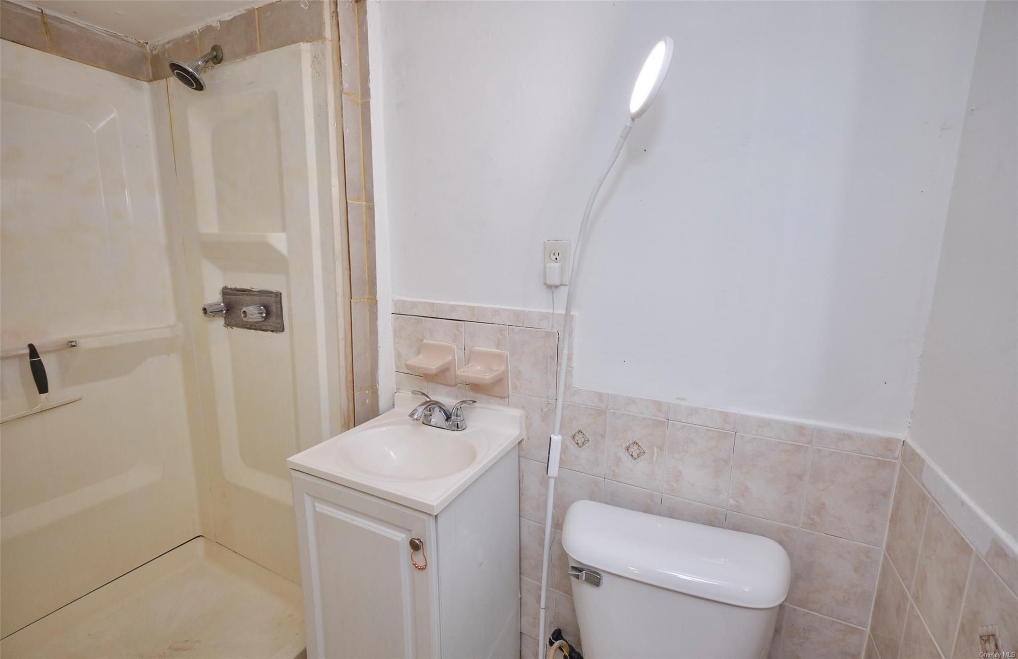 80-19 86th Road Queens, NY 11421 - Photo 17 of 26 a bathroom with a toilet a sink and shower