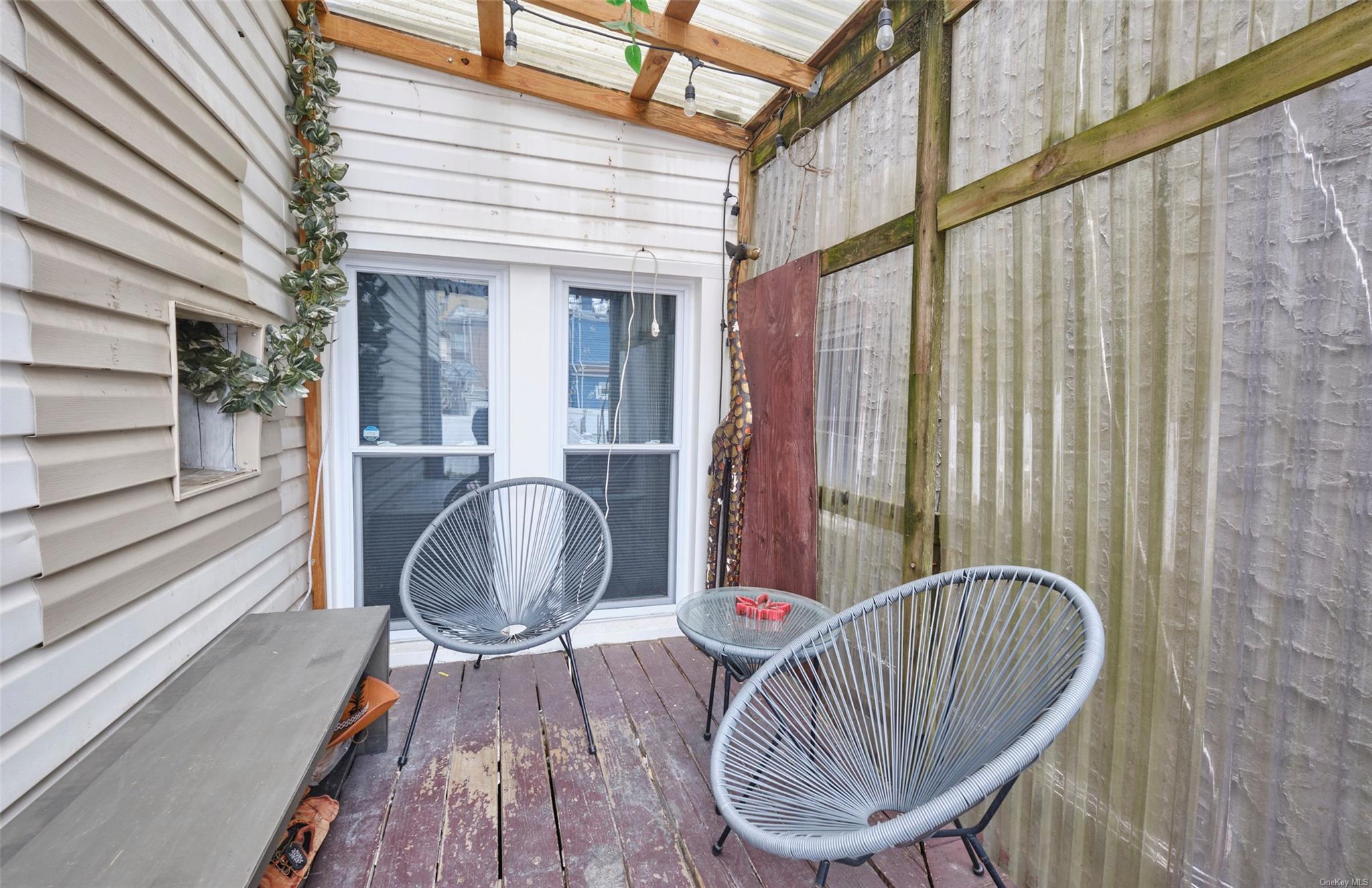 80-19 86th Road Queens, NY 11421 - Photo 19 of 26 a view of a balcony with chair and table