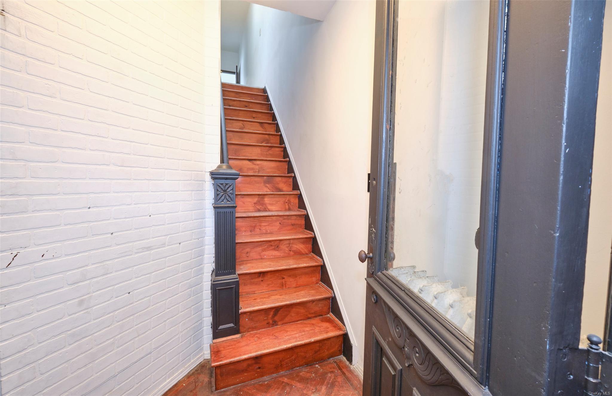 80-19 86th Road Queens, NY 11421 - Photo 10 of 26 a view of a staircase with wooden floor and staircase