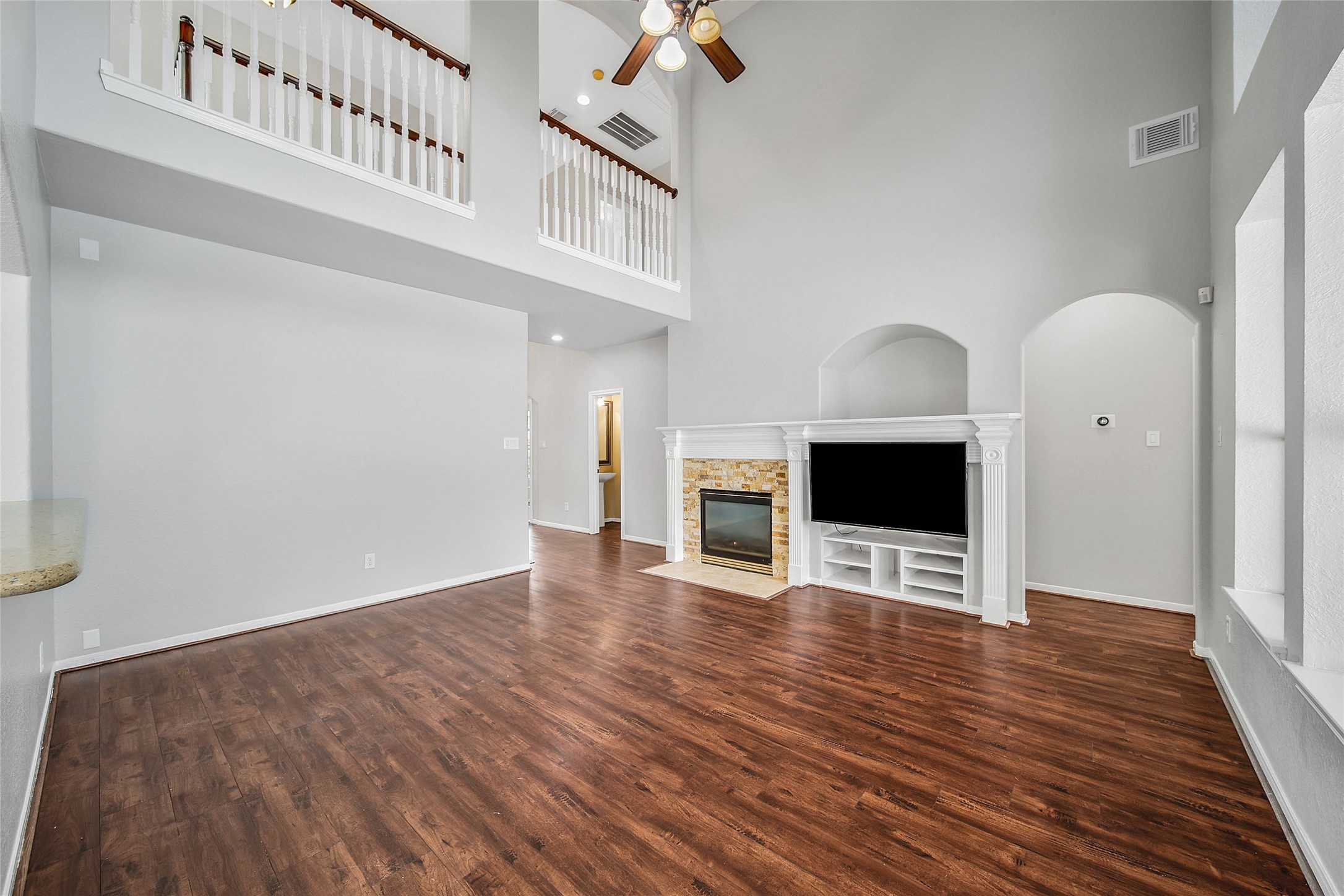 3 Murmuring Creek Place Conroe, TX 77385 - Photo 21 of 50 a view of an empty room with wooden floor and a fireplace
