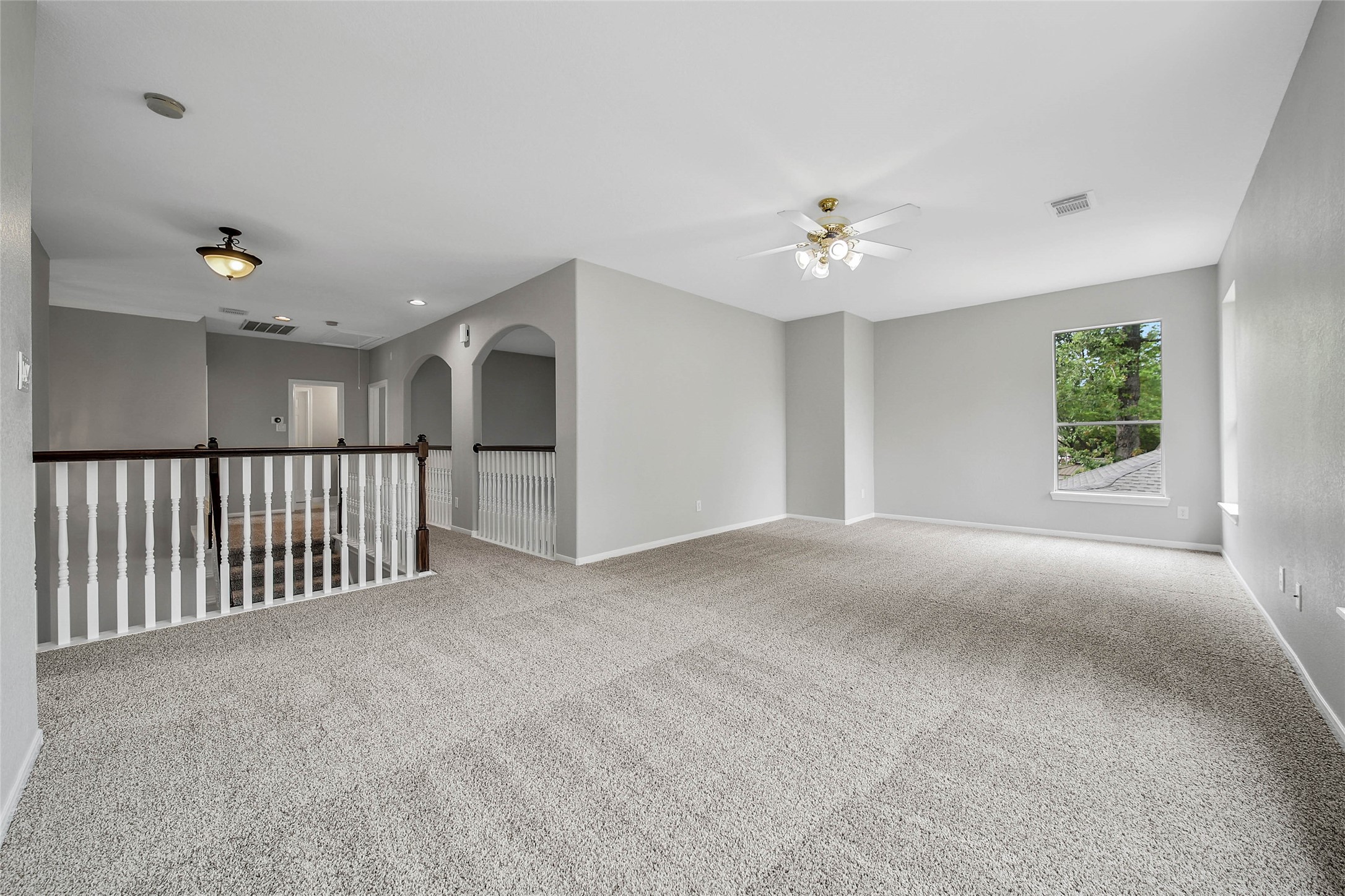 3 Murmuring Creek Place Conroe, TX 77385 - Photo 36 of 50 a view of a livingroom with a ceiling fan & windows