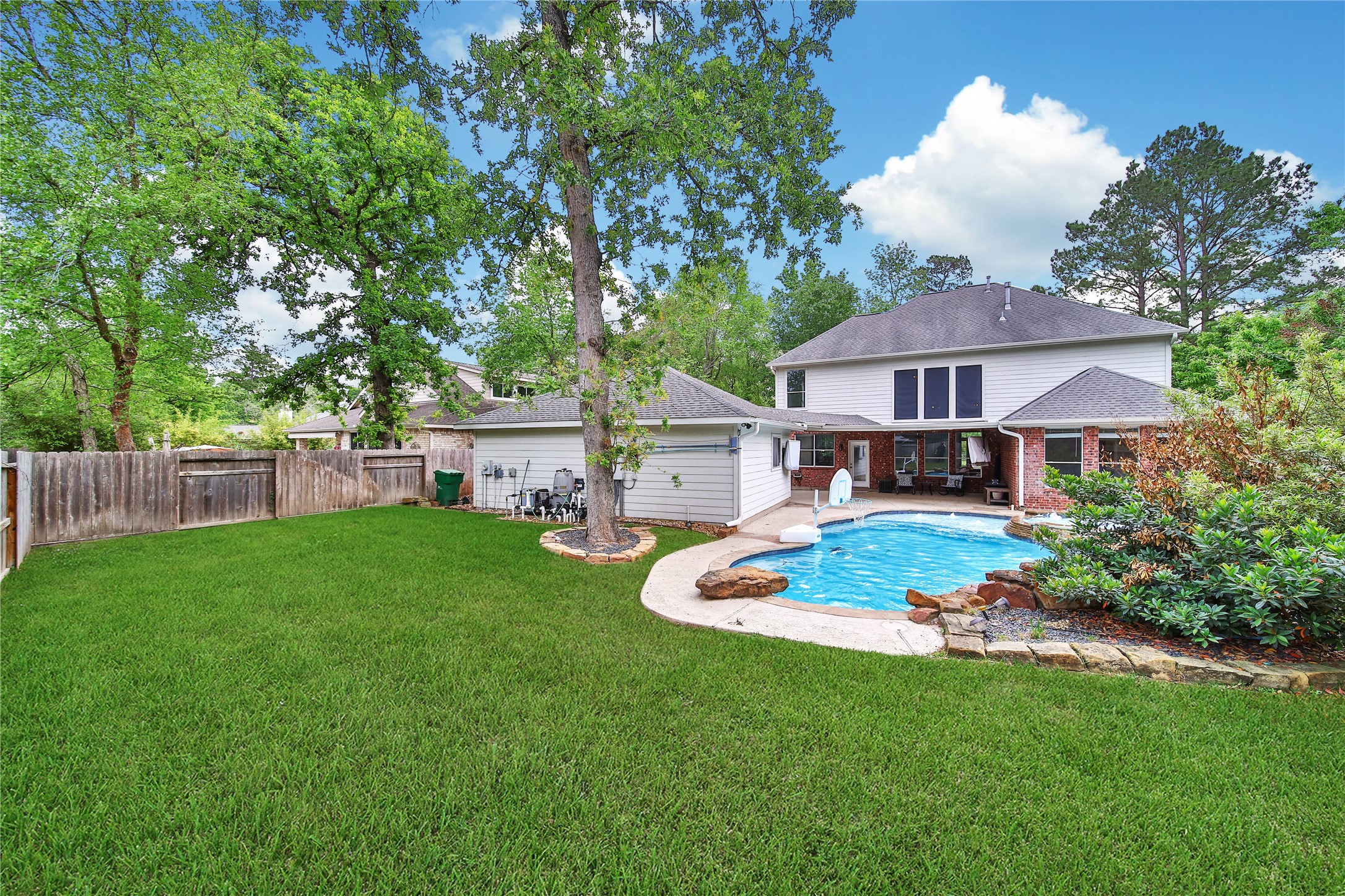 3 Murmuring Creek Place Conroe, TX 77385 - Photo 47 of 50 a front view of a house with a garden and porch