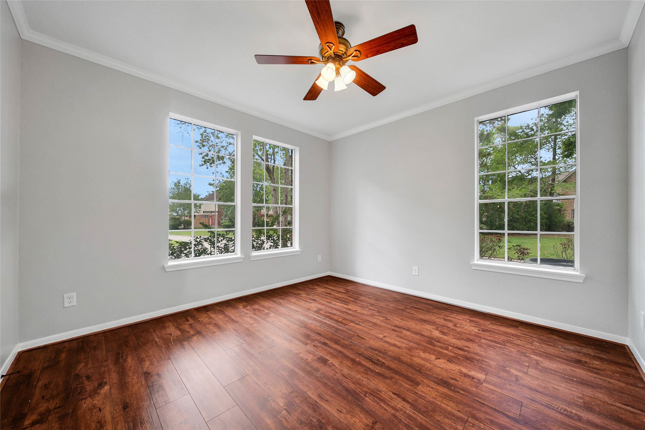 3 Murmuring Creek Place Conroe, TX 77385 - Photo 9 of 50 a view of an empty room with wooden floor and a window