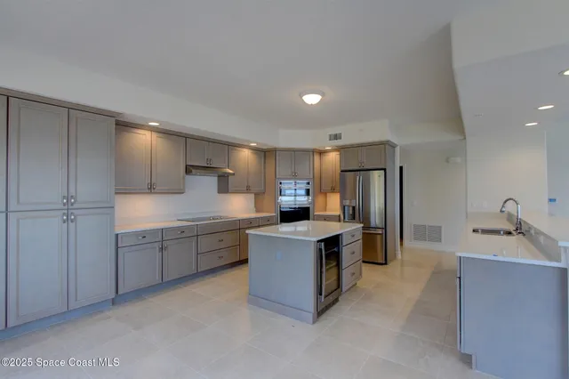 a kitchen with a stove window and cabinets