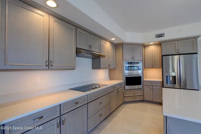 a kitchen with kitchen island white cabinets stainless steel appliances and sink