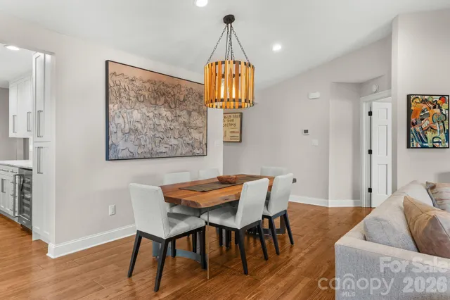 a dining room with furniture and wooden floor
