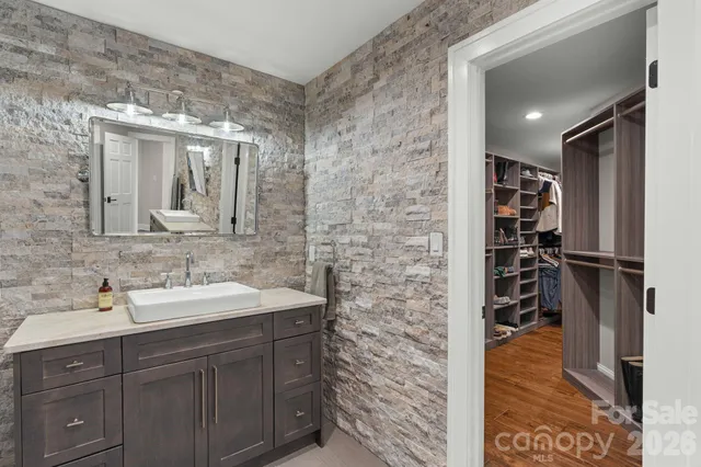 a bathroom with a sink a vanity and a mirror