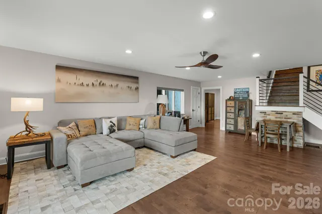 a living room with furniture and a wooden floor