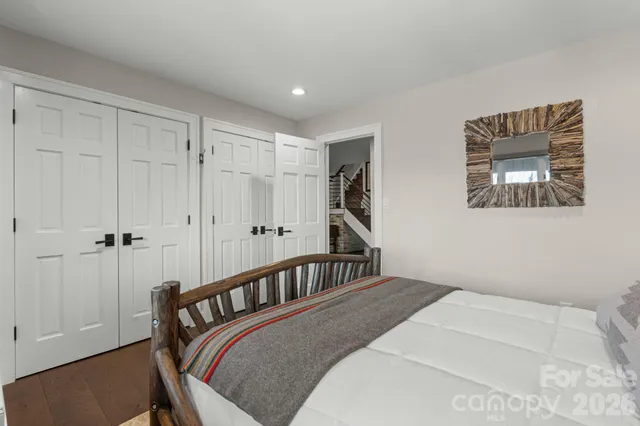 a bedroom with a bed next to a window