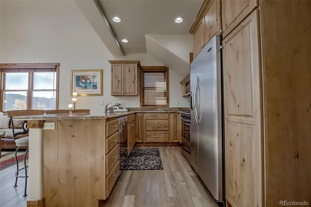 a kitchen with a refrigerator and a sink