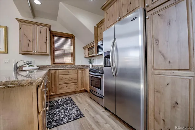 a kitchen with a refrigerator sink and stainless steel appliances