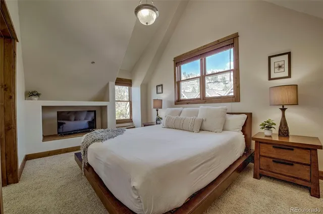 a bedroom with a bed and a fireplace