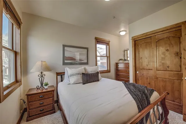 a bedroom with a bed and a dresser