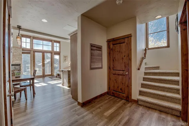 a view of a hallway with wooden floor and windows