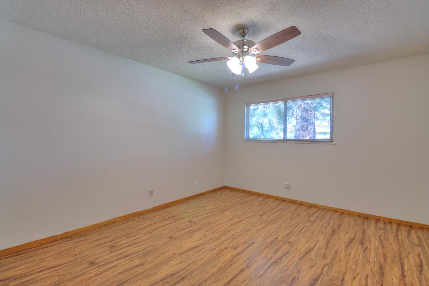 6265 North Colonial Avenue Fresno, CA 93704 - Photo 12 of 22 a view of empty room with wooden floor