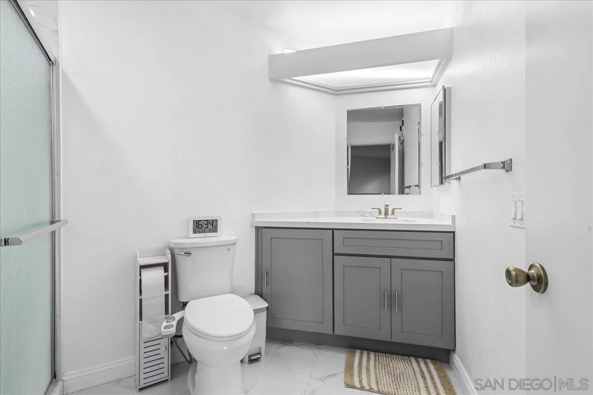 2916 Elm Tree Court Spring Valley, CA 91978 - Photo 20 of 38 a bathroom with a toilet sink and mirror