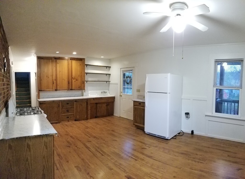 63 Harrington Street, Unit 2 Southbridge, MA 01550 - Photo 2 of 15 a large kitchen with kitchen island a sink stainless steel appliances and cabinets