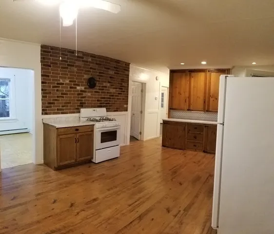 a kitchen with stainless steel appliances granite countertop a stove and a refrigerator