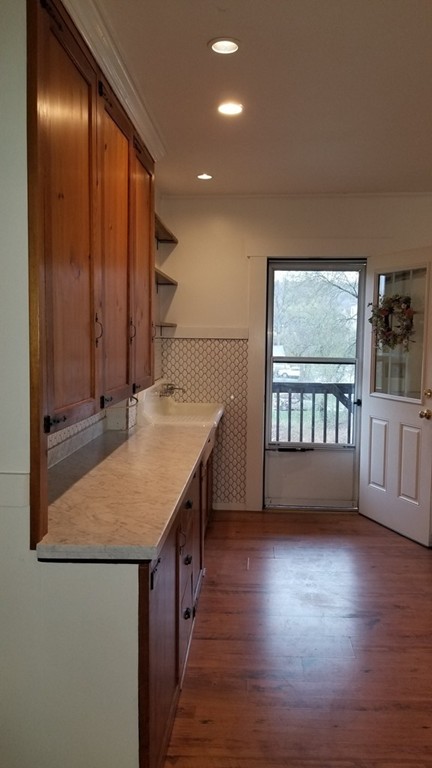 63 Harrington Street, Unit 2 Southbridge, MA 01550 - Photo 6 of 15 a view of kitchen with furniture and wooden floor