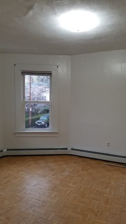 63 Harrington Street, Unit 2 Southbridge, MA 01550 - Photo 7 of 15 an empty room with a window