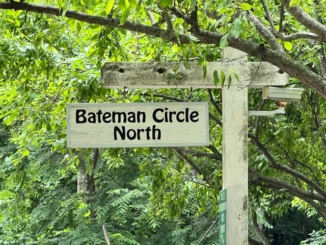 a sign of golf club on a tree