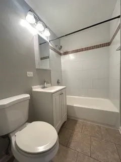 a bathroom with a sink mirror vanity and toilet