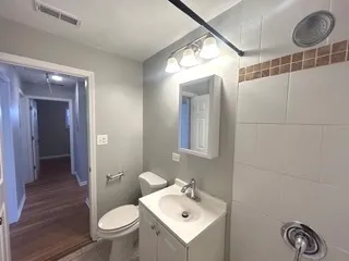 a bathroom with a sink mirror vanity and toilet