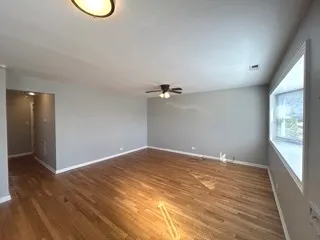 a view of a room with wooden floor and bathroom
