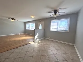 a view of a livingroom with a ceiling fan and window