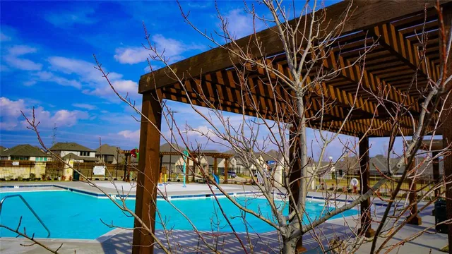 a view of a swimming pool with outdoor seating