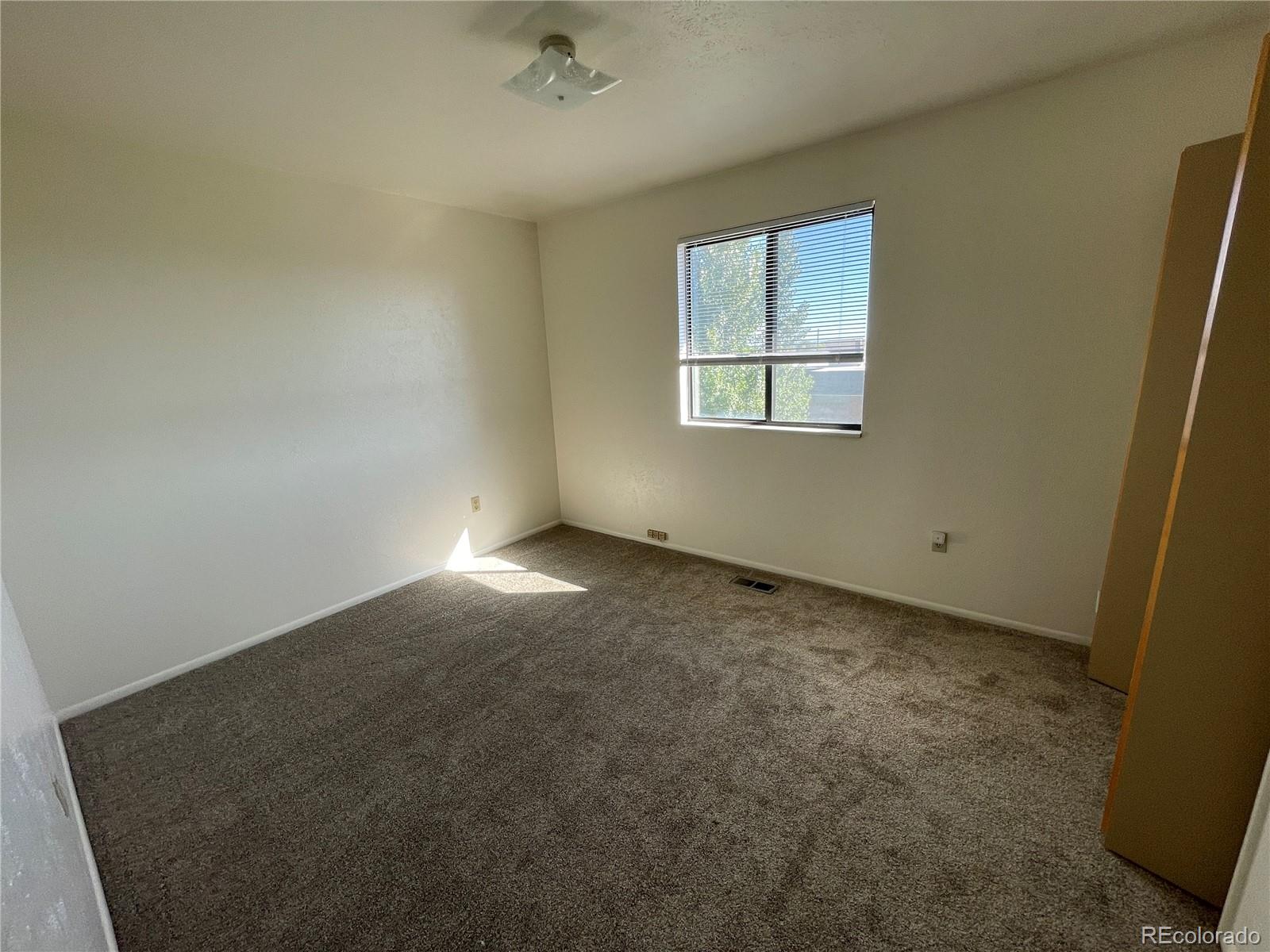 4820 West 88th Place Westminster, CO 80031 - Photo 15 of 21 an empty room with a window