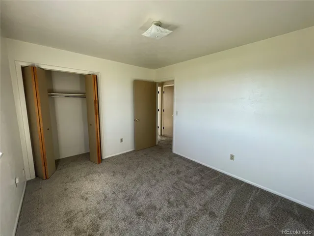 an empty room with closet area