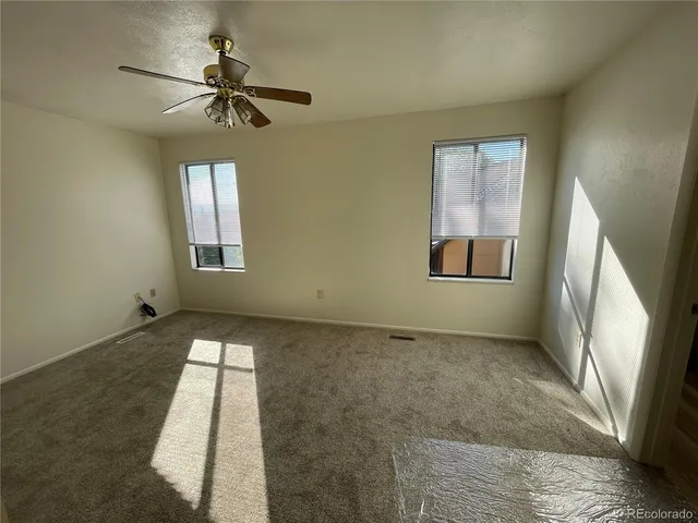 a view of an empty room and a window
