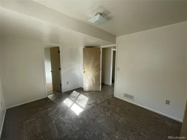 an empty room with windows and entrance