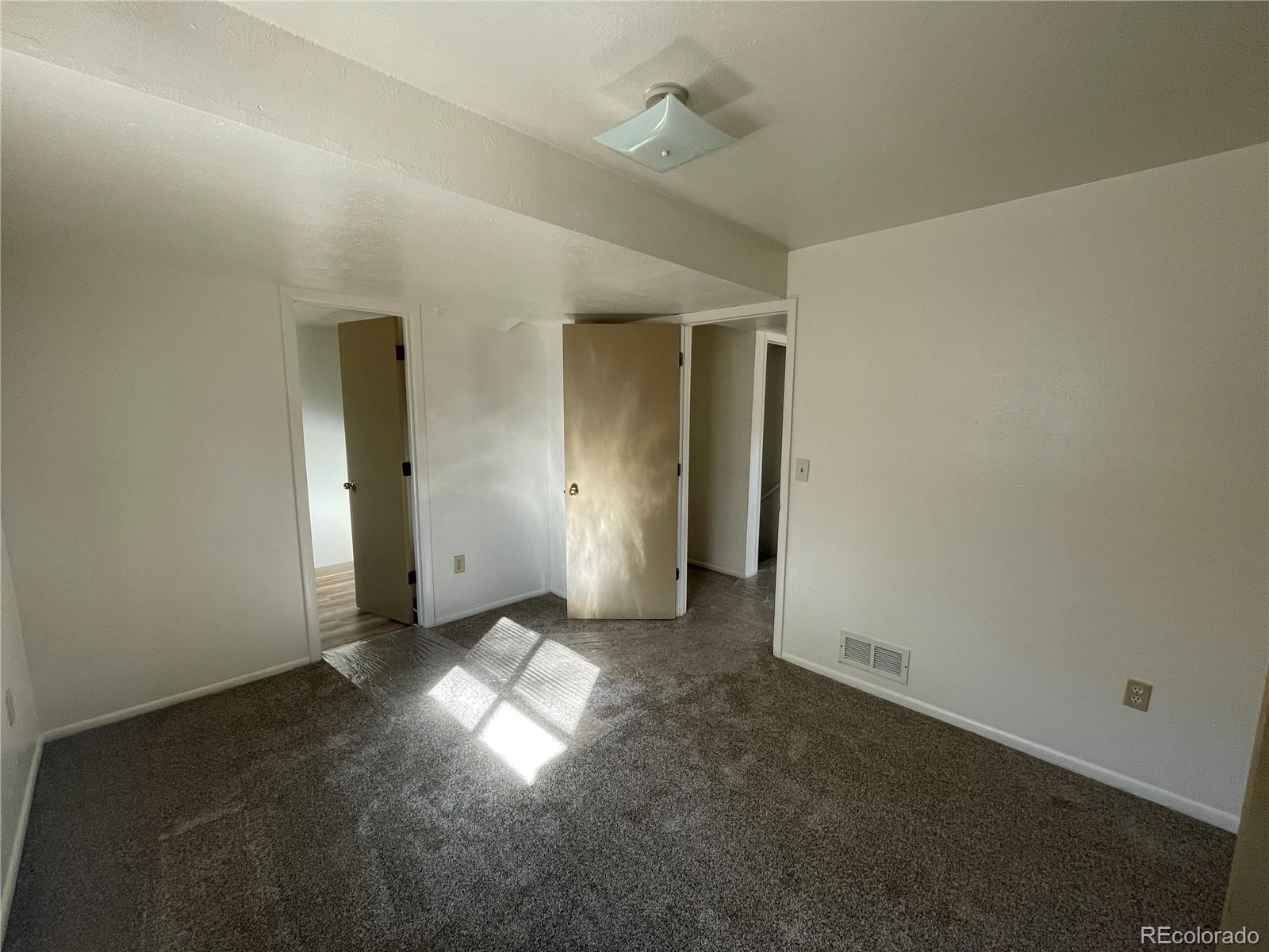 4820 West 88th Place Westminster, CO 80031 - Photo 10 of 21 an empty room with windows and entrance