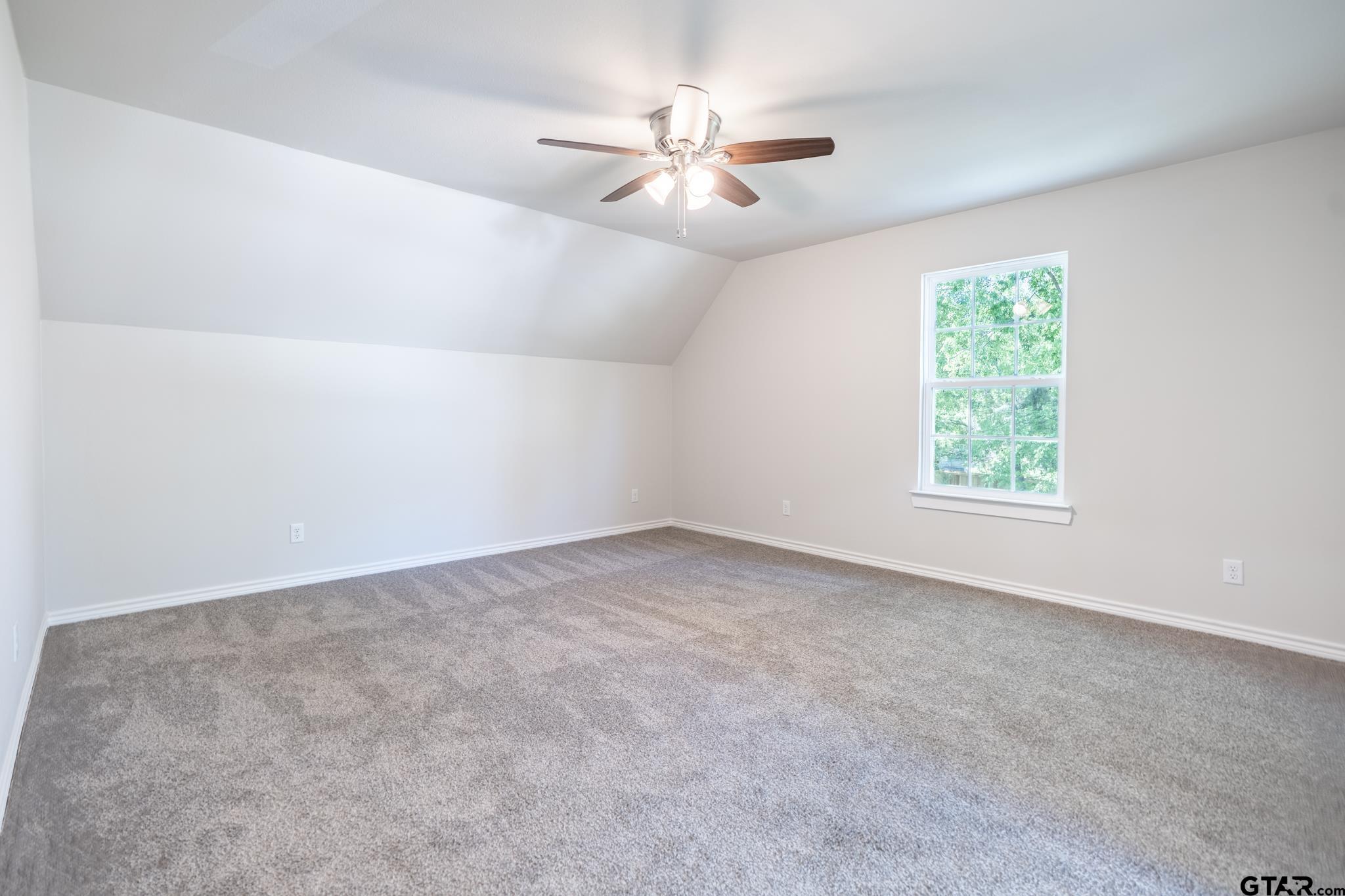 233 Harrison Street Longview, TX 75601 - Photo 27 of 44 an empty room with windows and fan