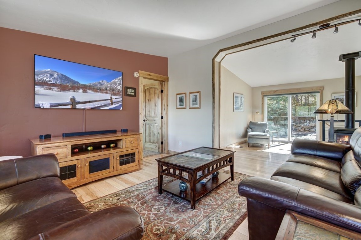 379 Hummingbird Circle Silverthorne, CO 80498 - Photo 11 of 44 a living room with furniture and a flat screen tv