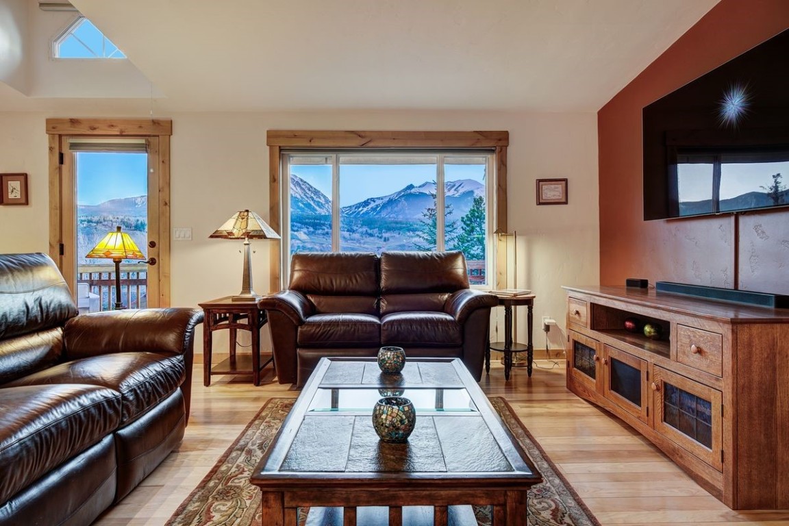 379 Hummingbird Circle Silverthorne, CO 80498 - Photo 12 of 44 a living room with furniture and a wooden floor