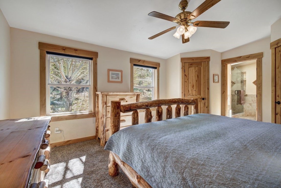 379 Hummingbird Circle Silverthorne, CO 80498 - Photo 13 of 44 a bed sitting in a bedroom next to a window